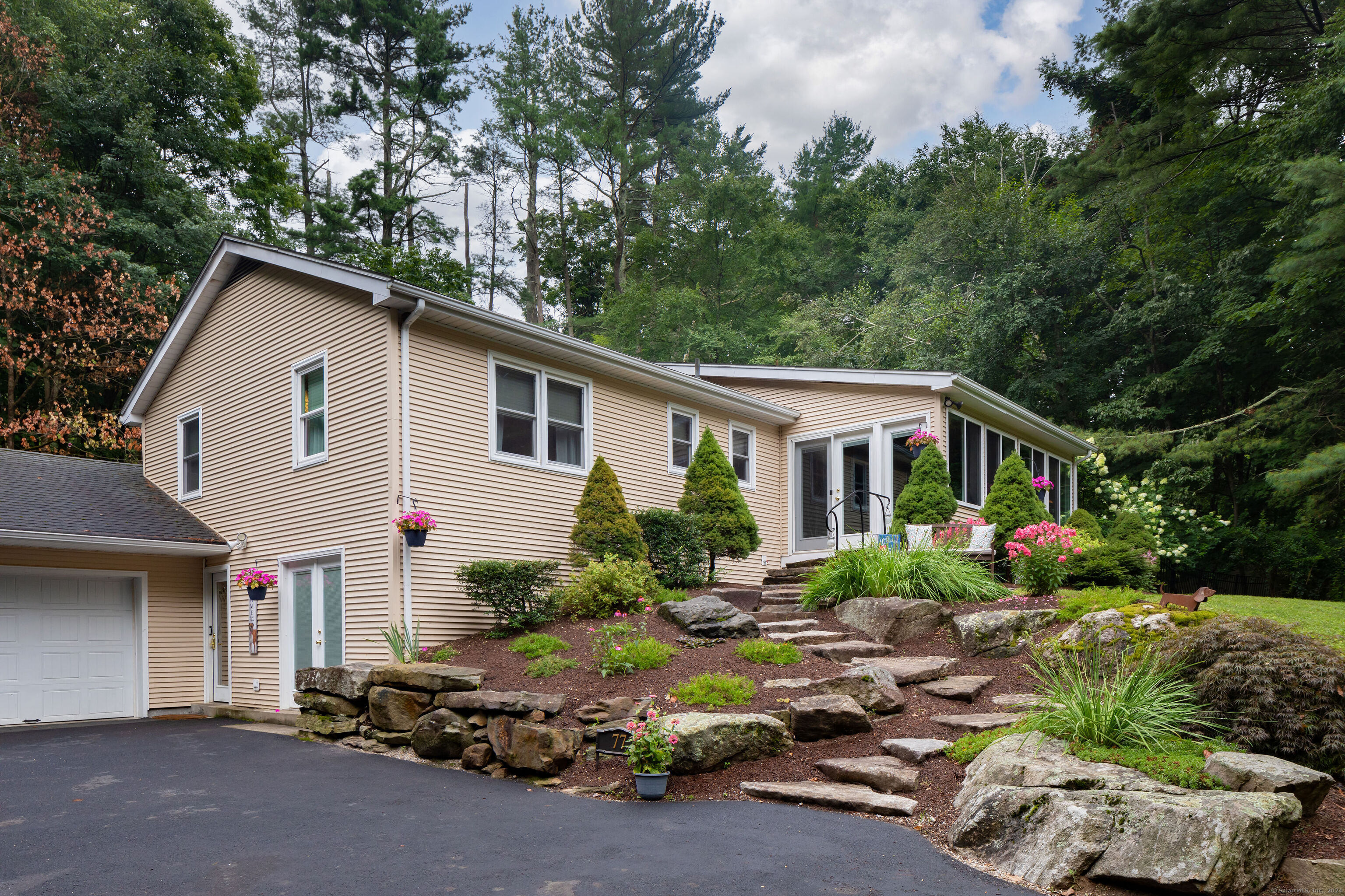 a front view of a house with a yard and outdoor seating