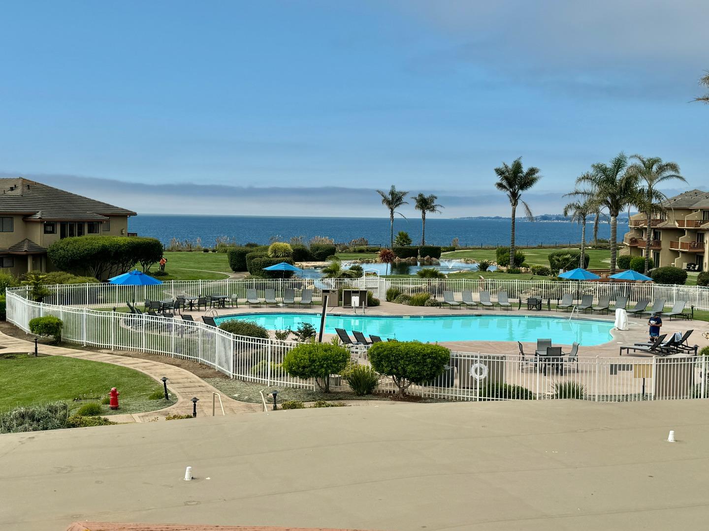 a view of a swimming pool and outdoor seating