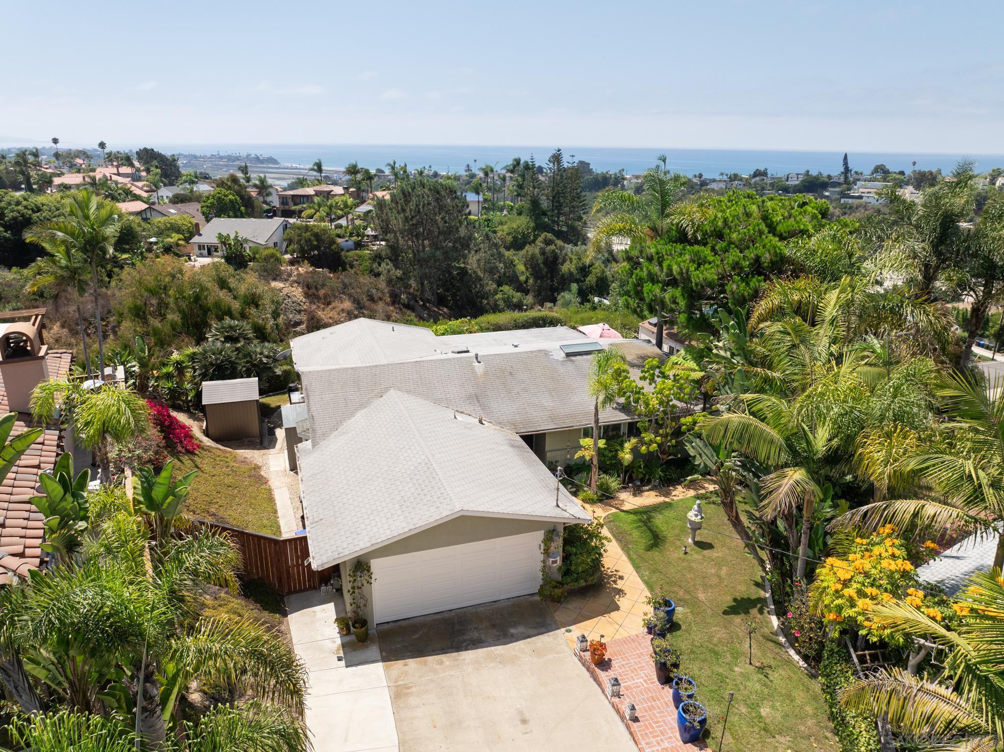 an aerial view of a house with yard