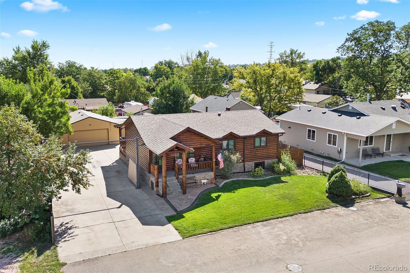 a aerial view of a house with a yard and potted plants