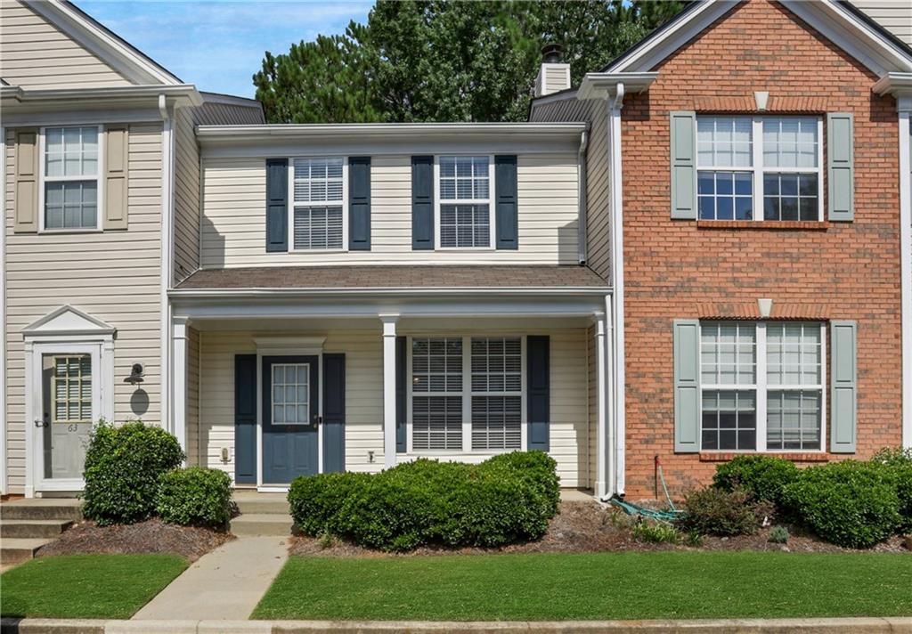 front view of a brick house with a yard