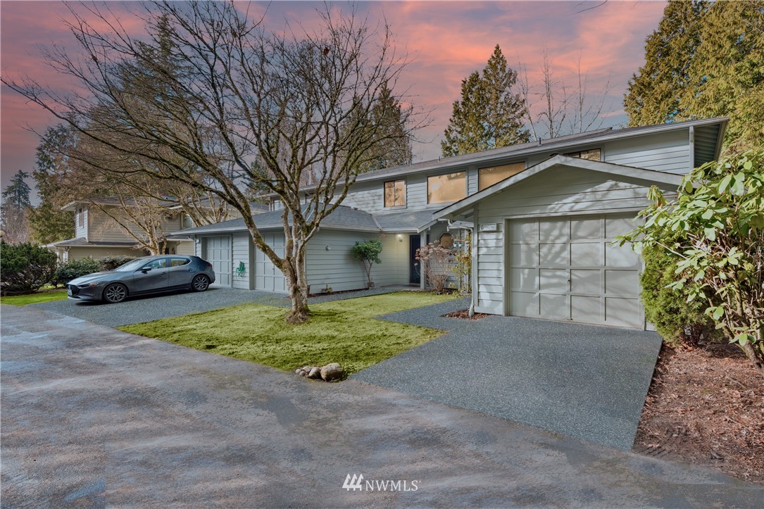 a view of a house with a yard and garage