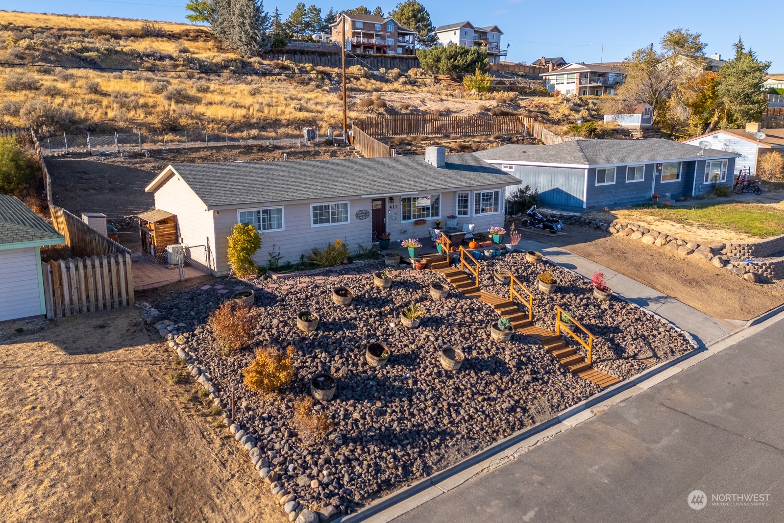 an aerial view of a house roof deck with couches table and chairs