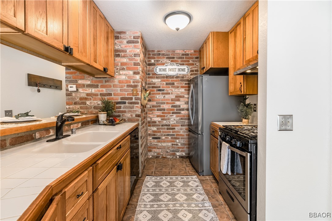 a kitchen with a sink stove and cabinets