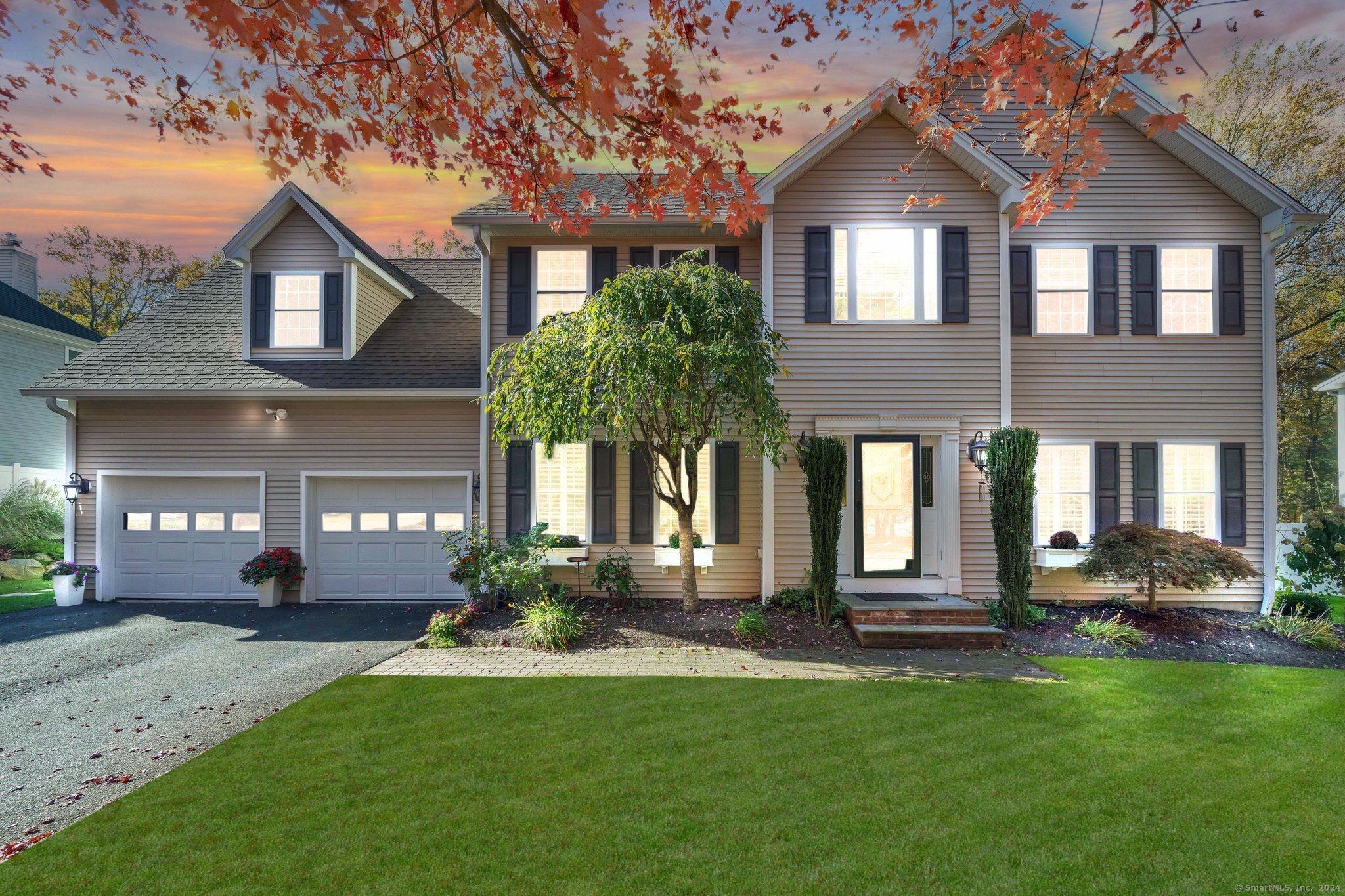 a front view of a house with a yard and garage