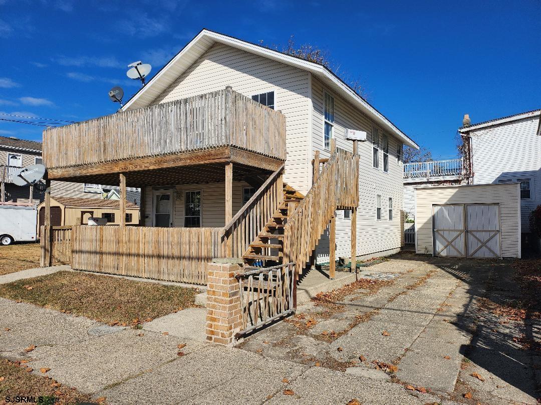 a view of a house with wooden fence