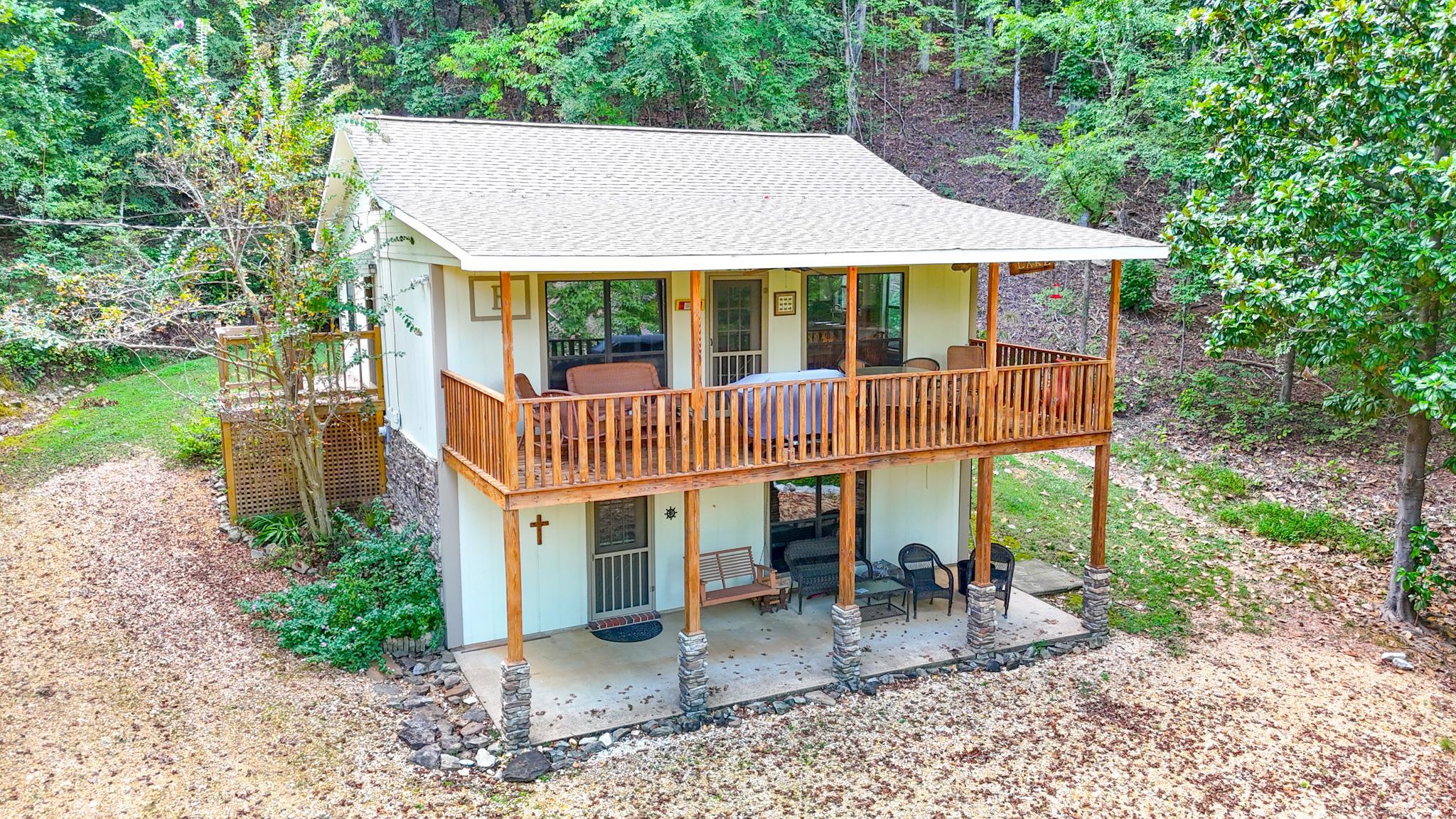 Rear view of property featuring a deck and a patio