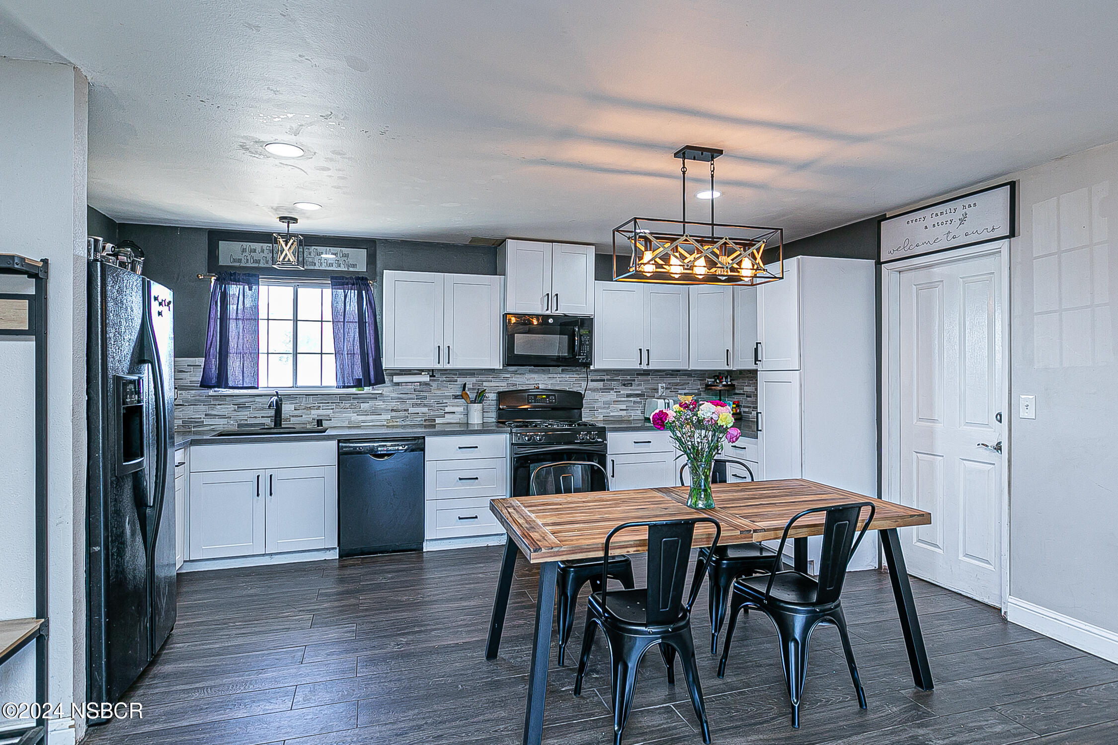 a kitchen that has a table and chairs in it