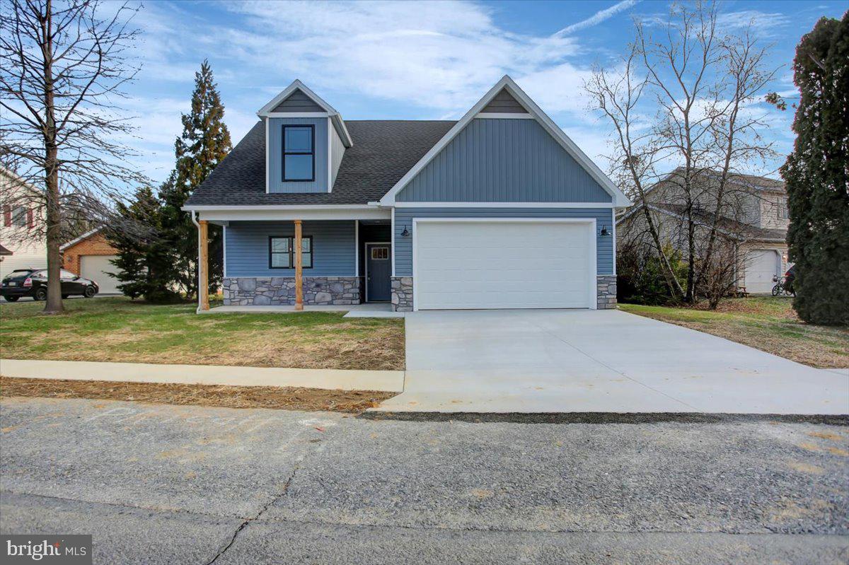 a front view of house with yard and trees around