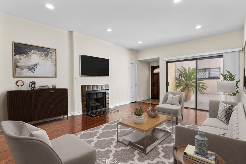 a living room with furniture a fireplace and a flat screen tv