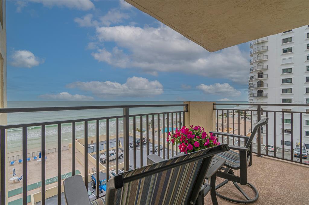 a balcony view with a seating space