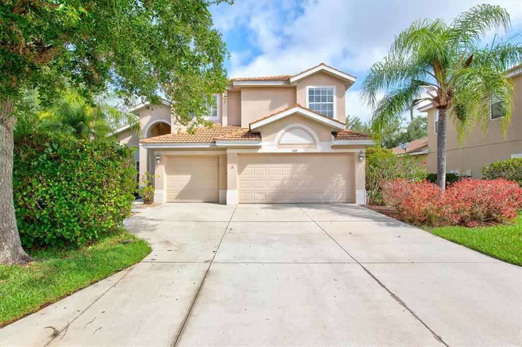 a front view of a house with a yard and a garage