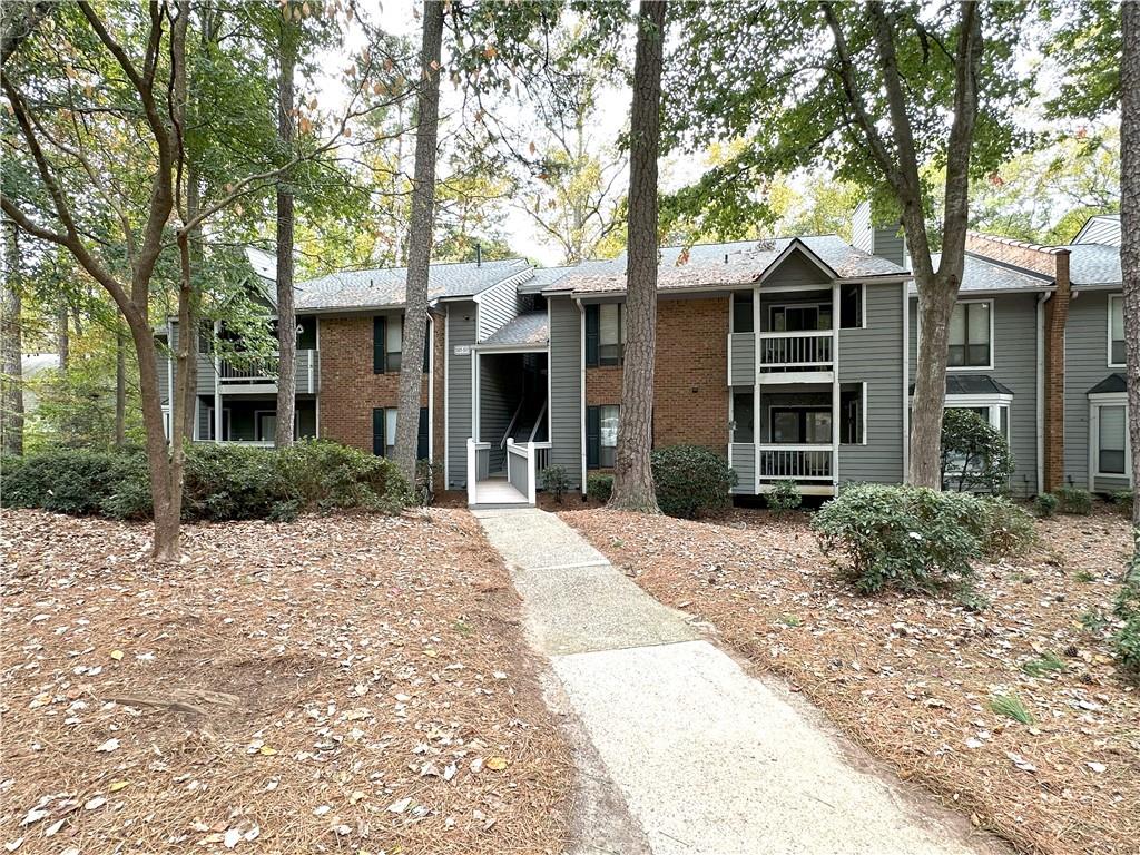 a front view of a house with a yard and trees