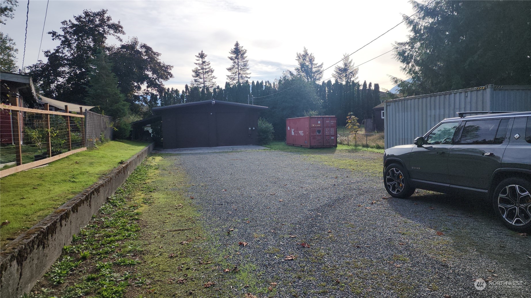 a view of a backyard with parked car