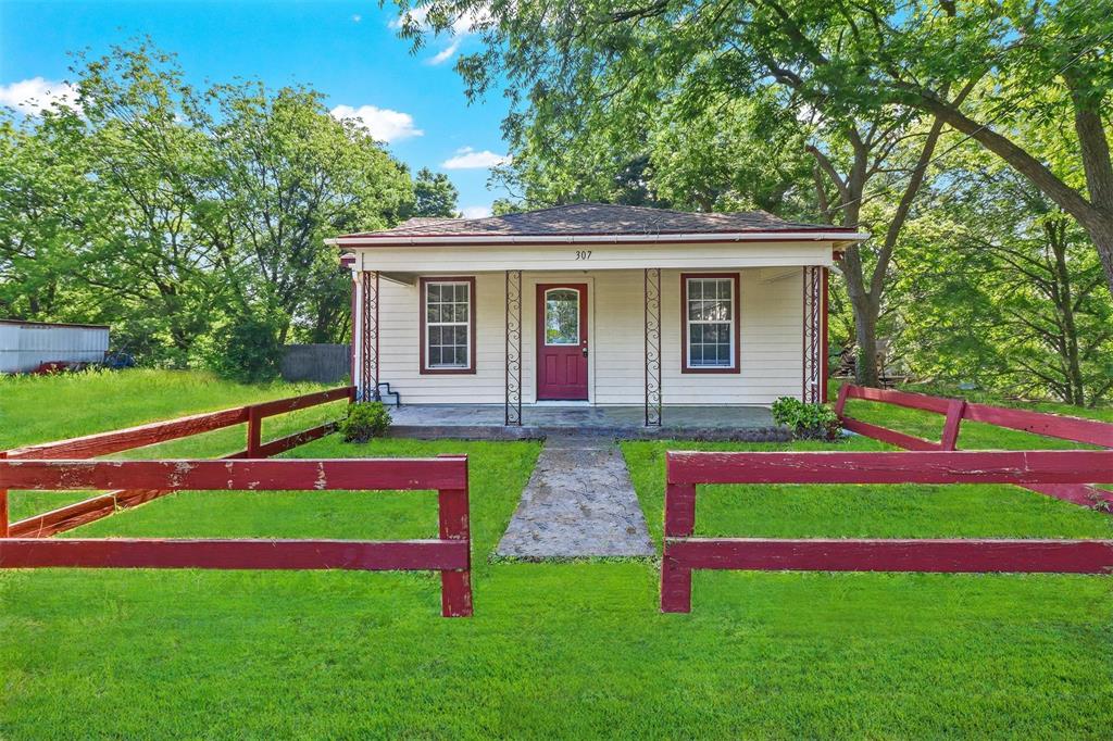 a front view of house with yard and outdoor seating