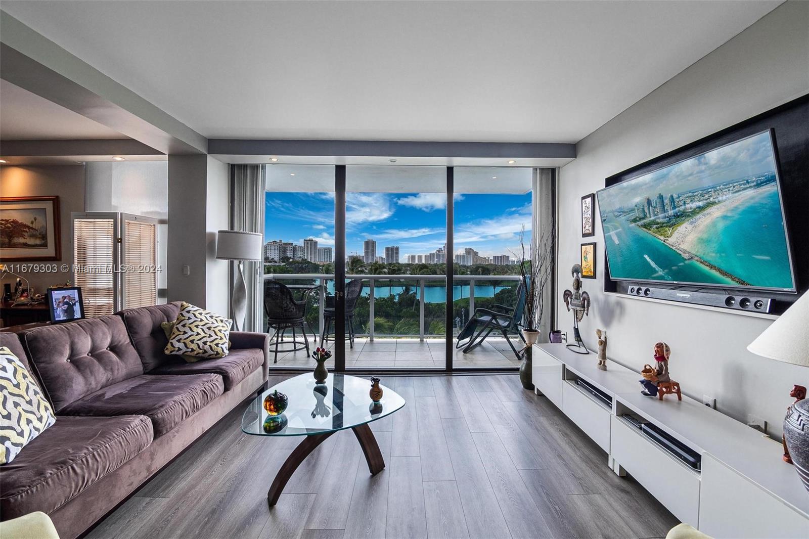 a living room with furniture tv and a large window