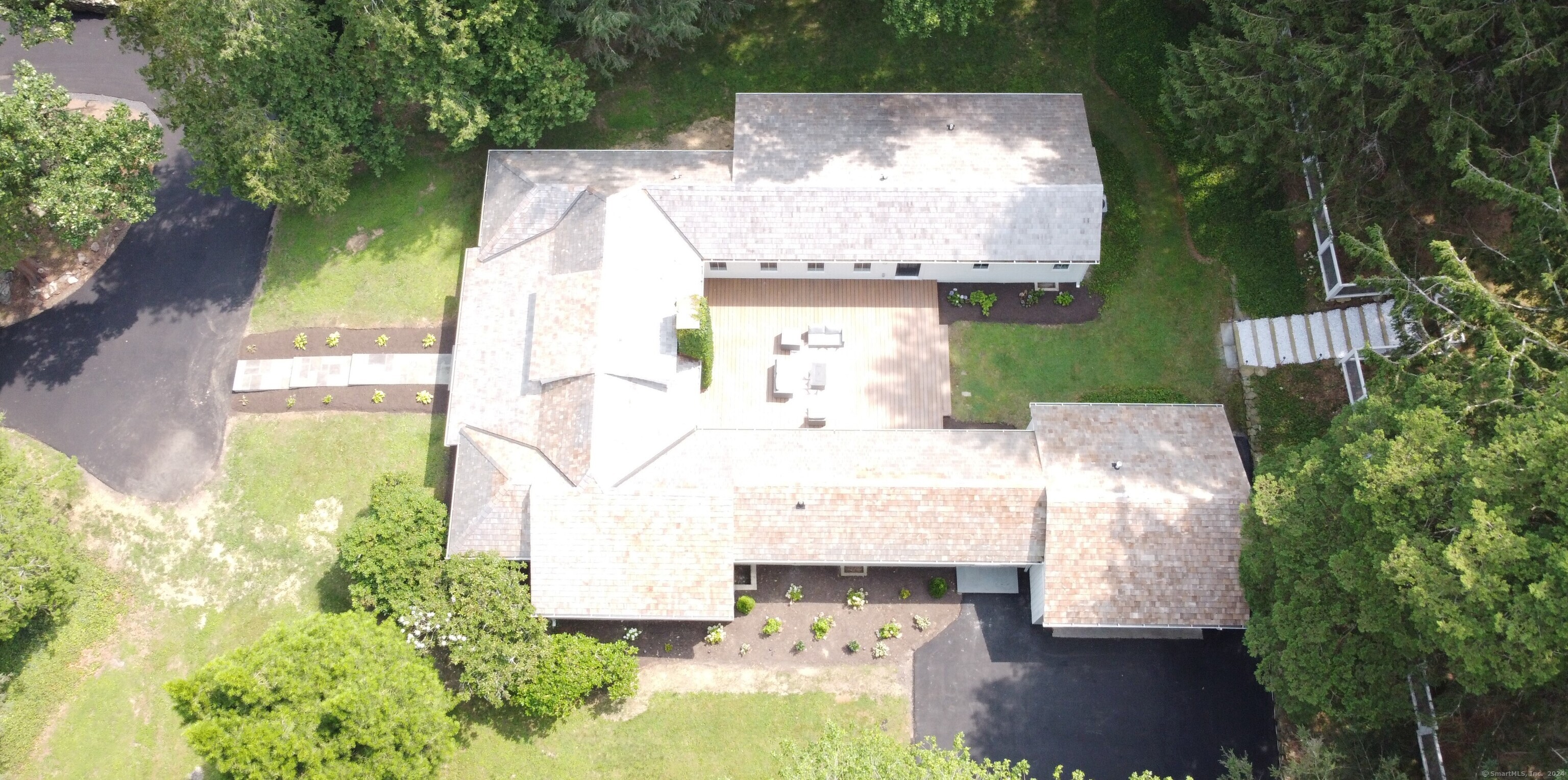 an aerial view of a house with a yard