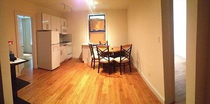 a dining room with furniture and wooden floor