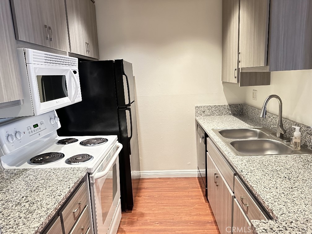 a kitchen with a sink stove and refrigerator