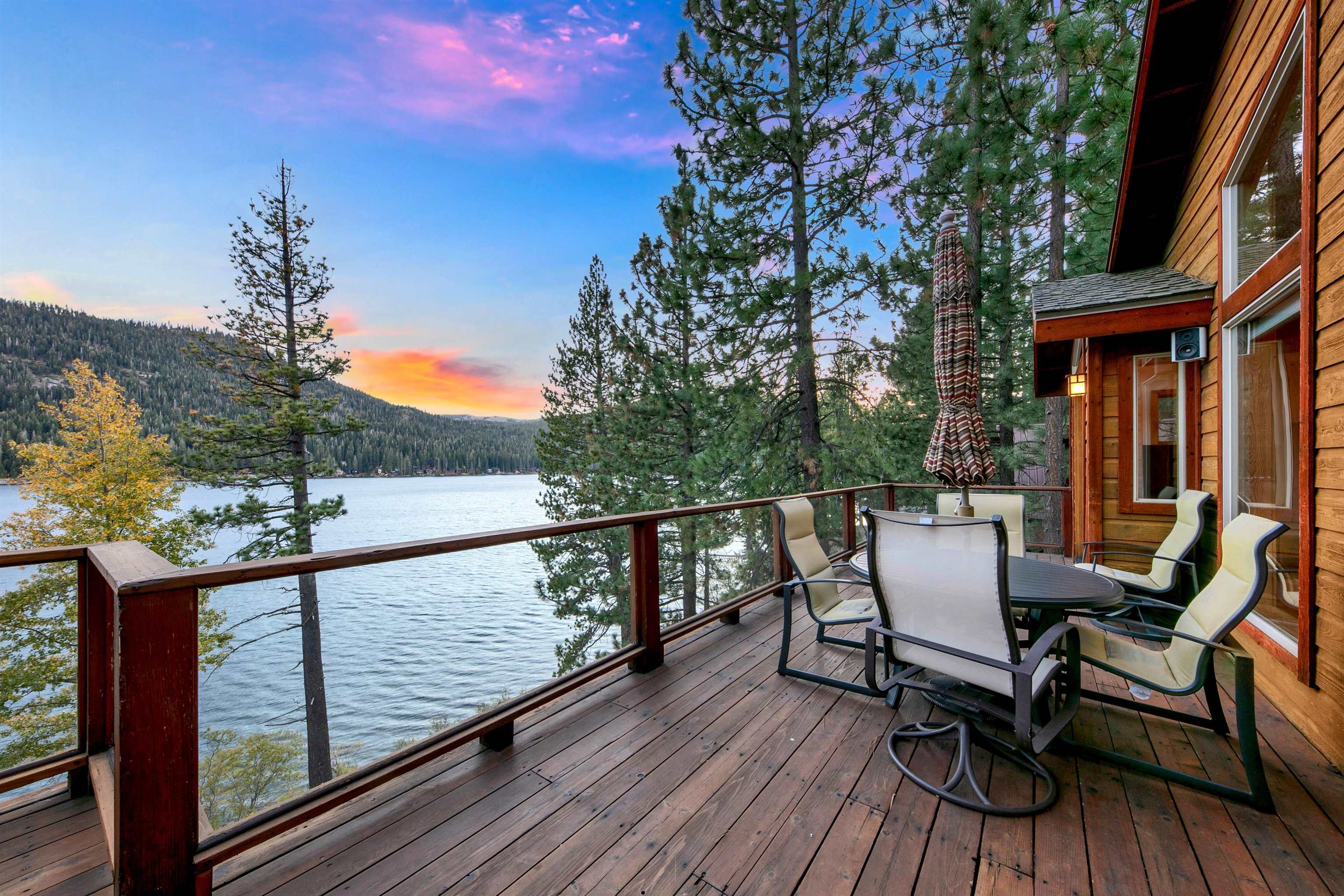 a view of a deck with table and chairs and wooden floor