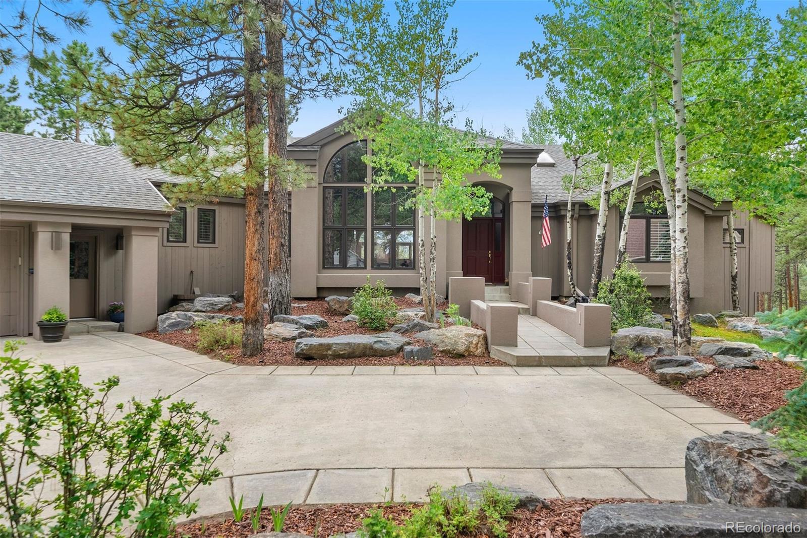 a view of a house with backyard and sitting area