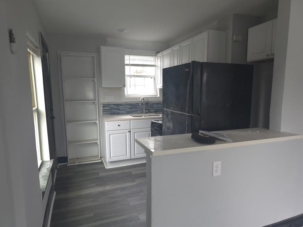 a kitchen with a sink and a refrigerator