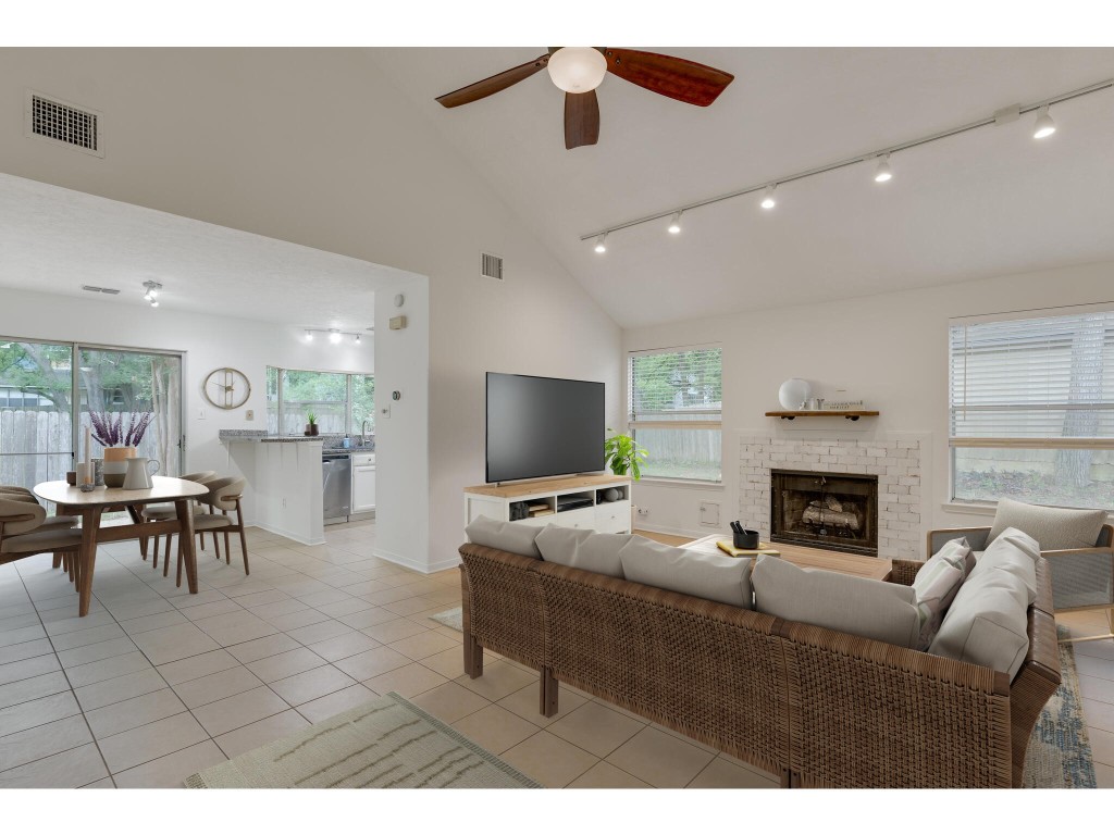 a living room with furniture a fireplace and a flat screen tv