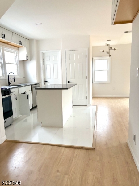 a large white kitchen with wooden floors