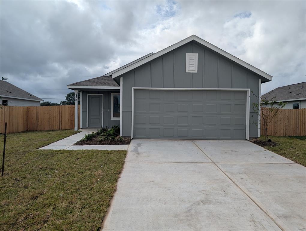 a front view of house with yard garage and garage