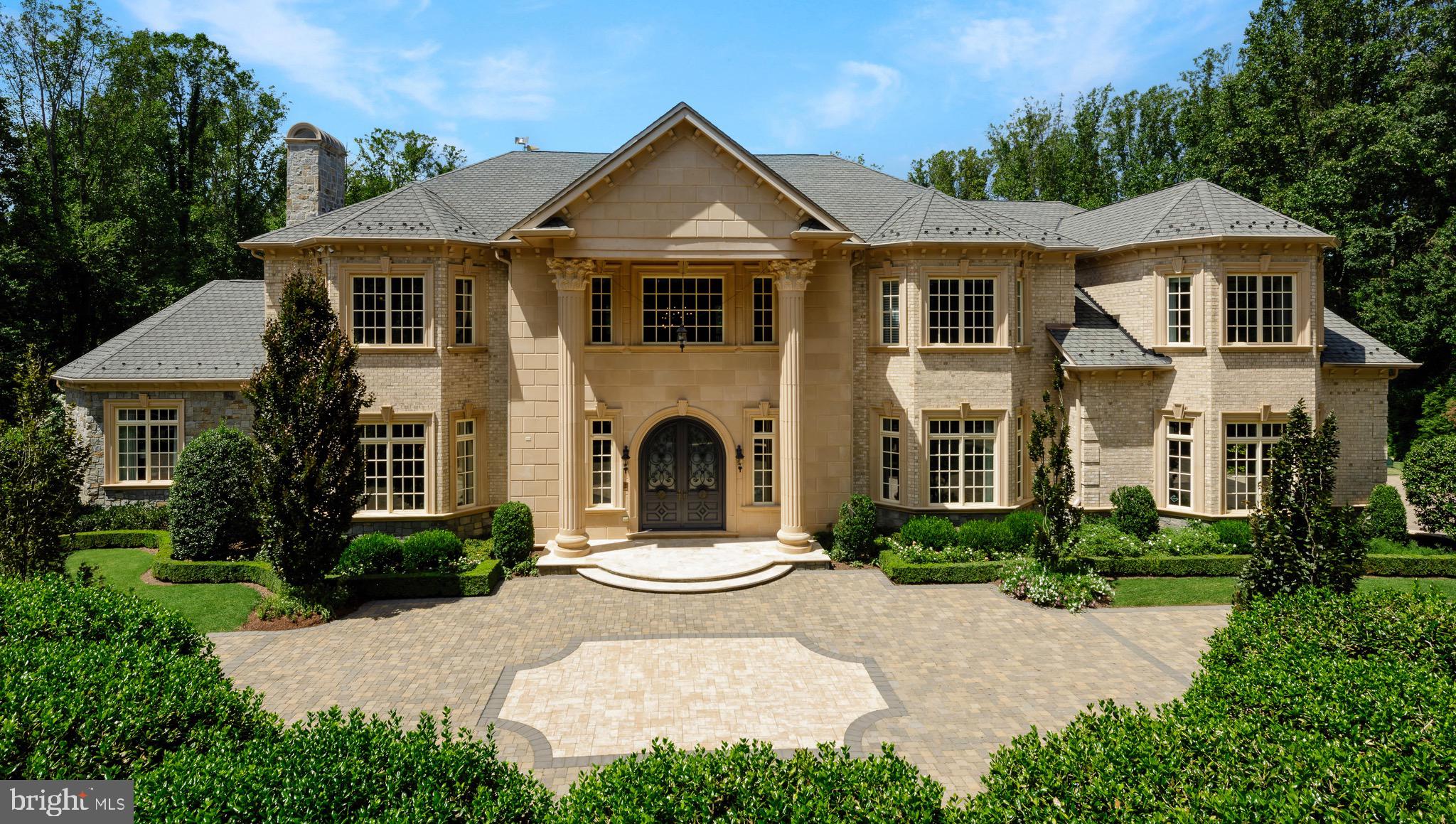 a front view of a house with a yard outdoor seating and garage