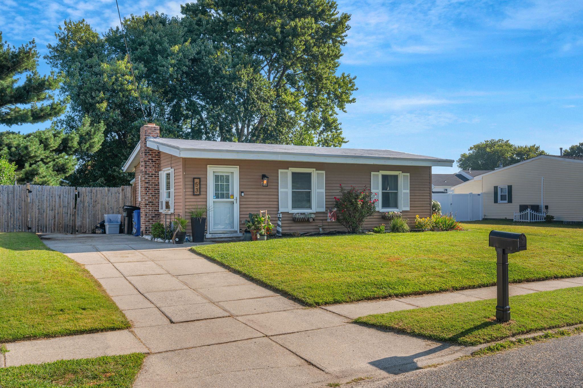 a front view of house with yard and green space