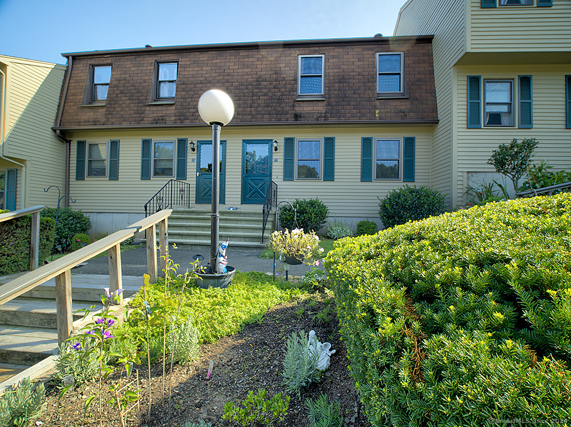 a front view of a house with garden