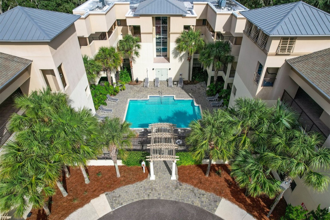 an aerial view of a house with garden space and a chairs