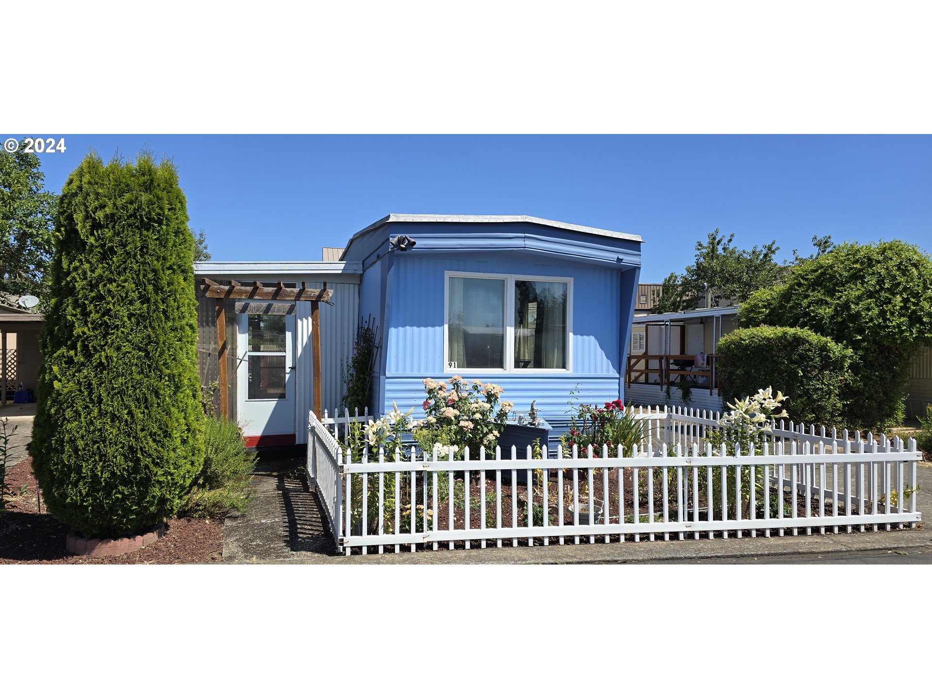 a front view of a house with a garden