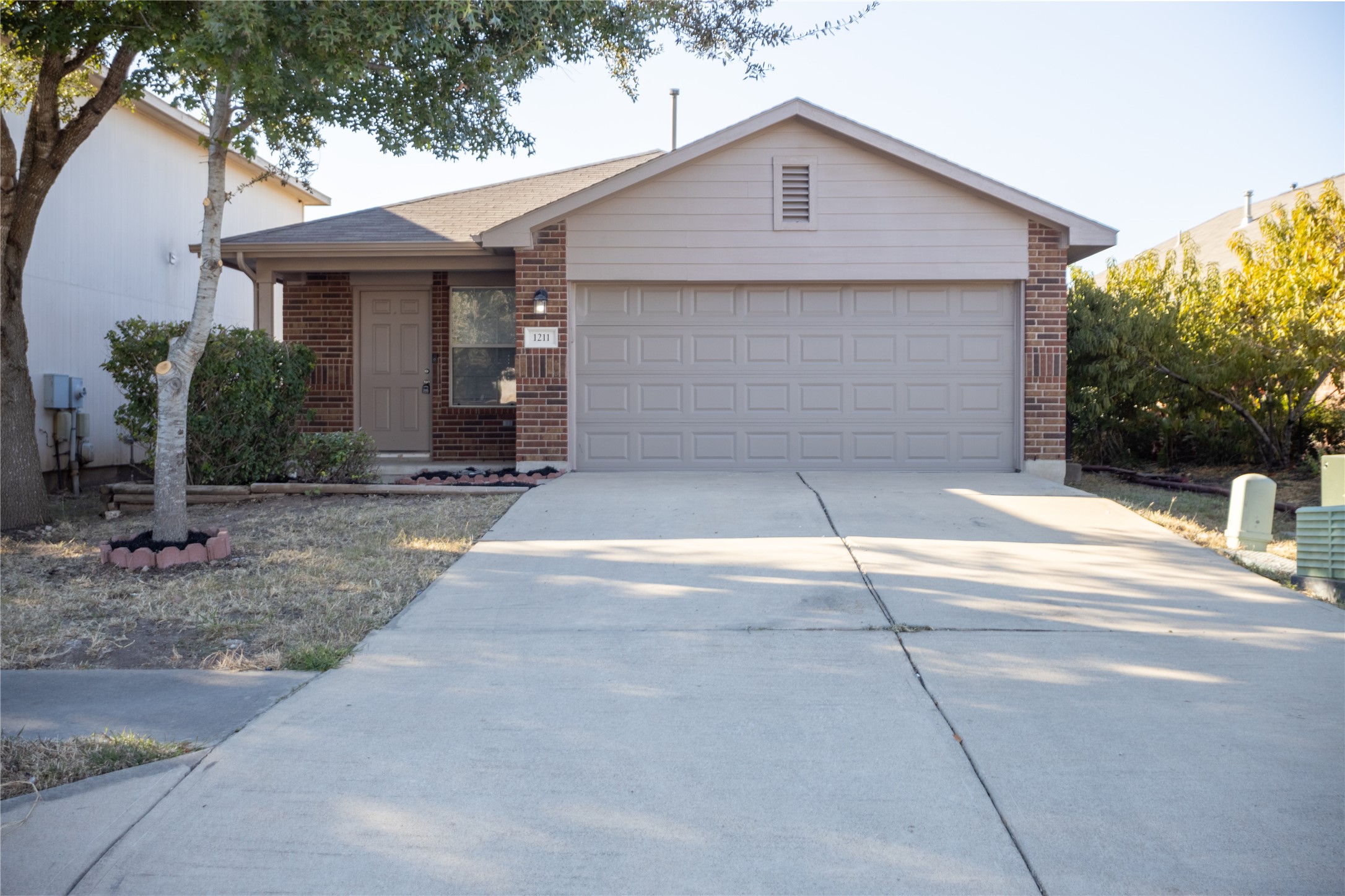 a view of a house with a yard and garage