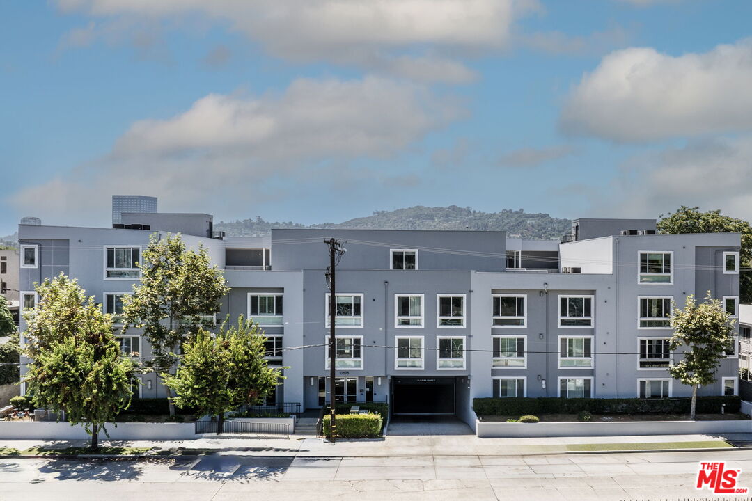 a front view of a building with a garden