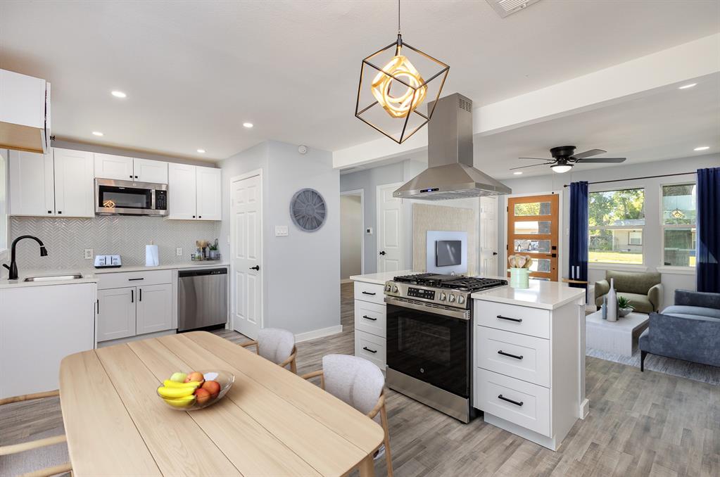 a kitchen with a stove a sink and a refrigerator