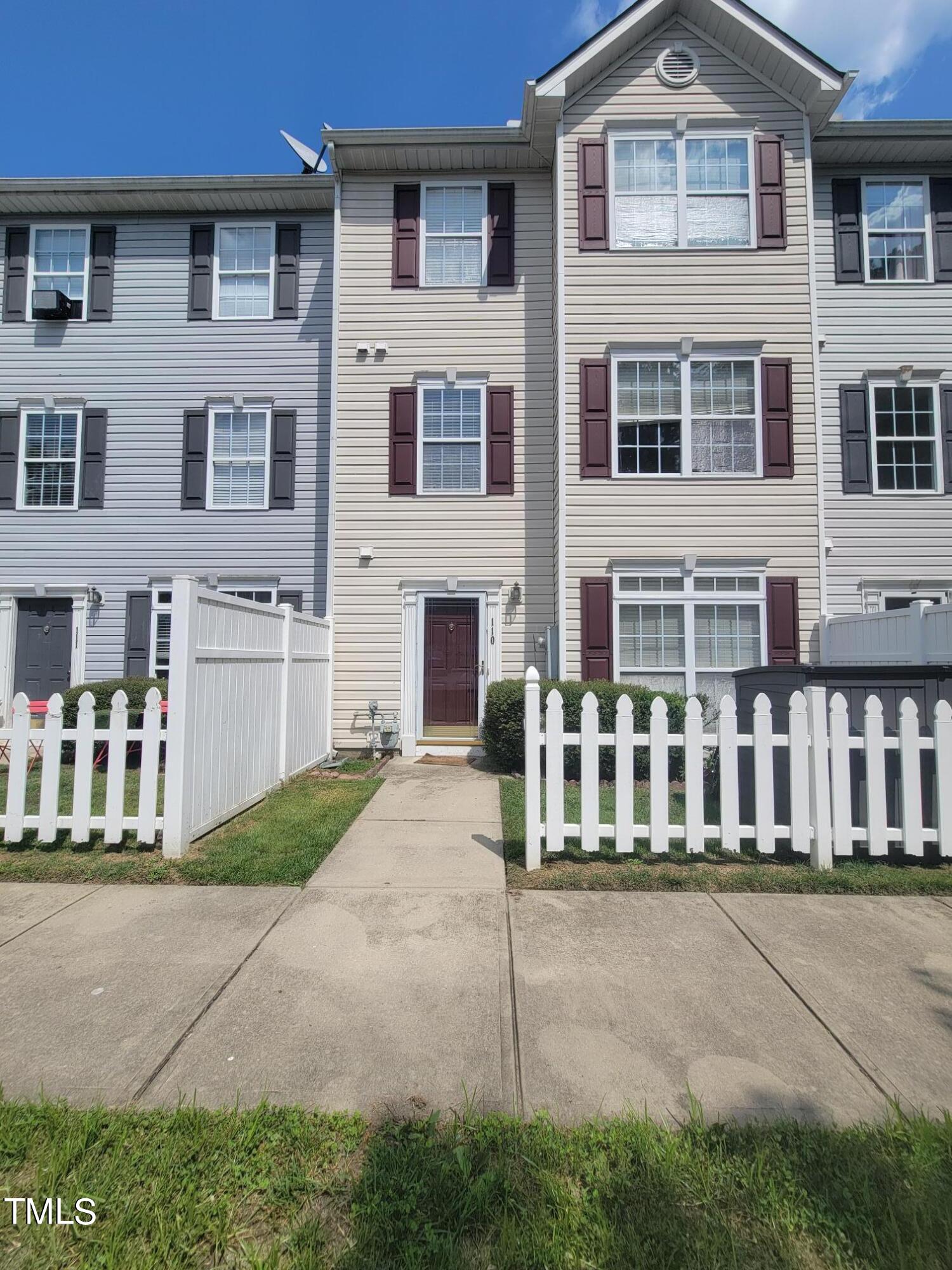 a front view of a residential apartment building with a yard