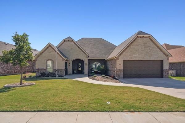 a view of a house with swimming pool and a yard