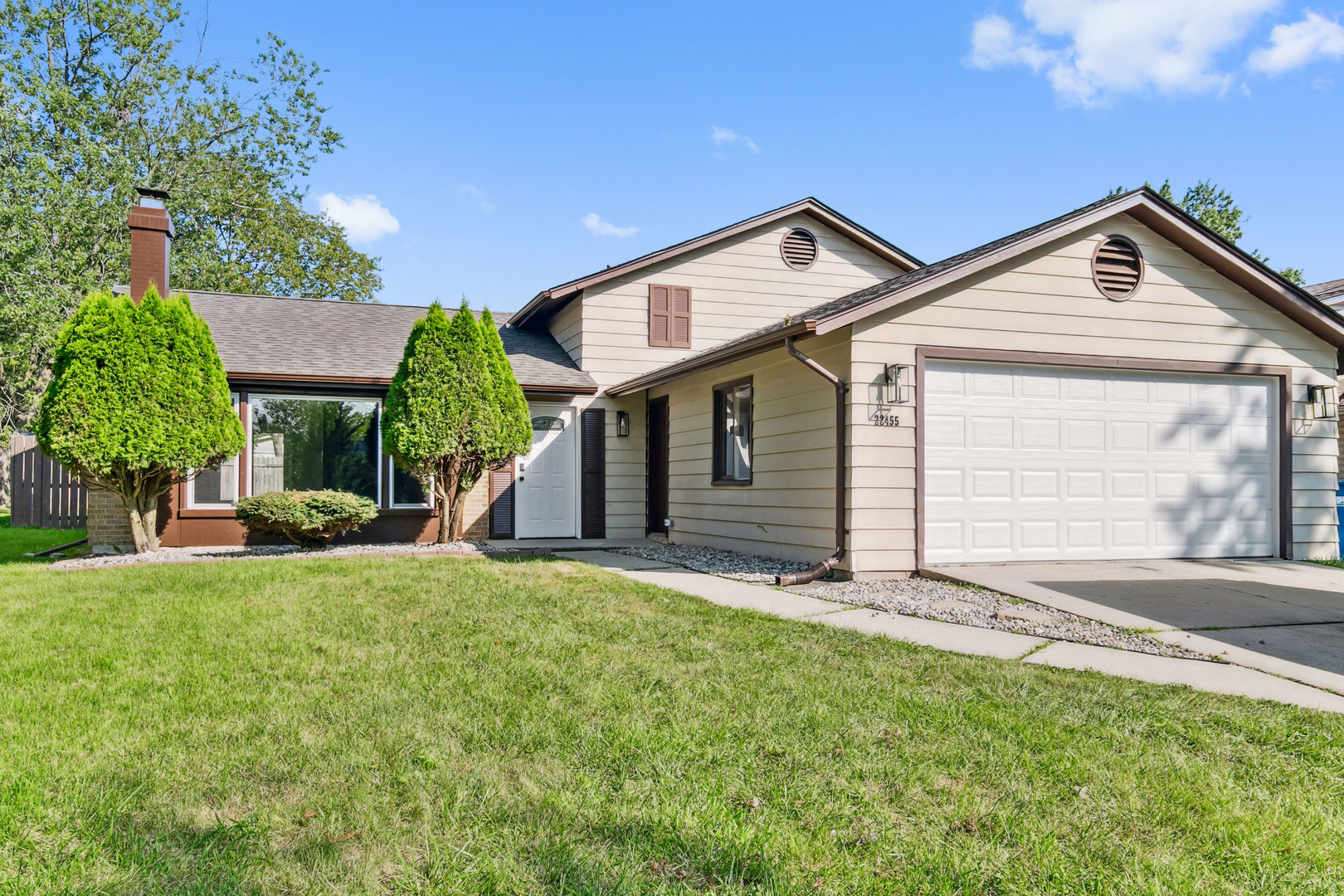 a view of a house with yard and tree s