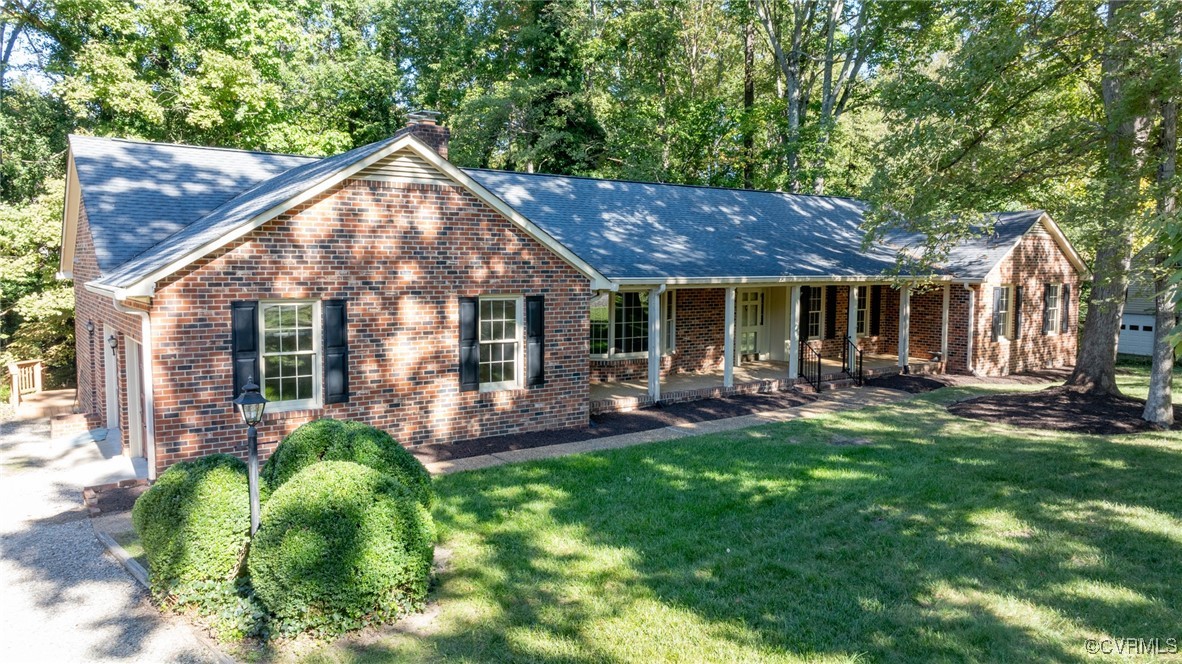 a view of a house with a yard porch and sitting area