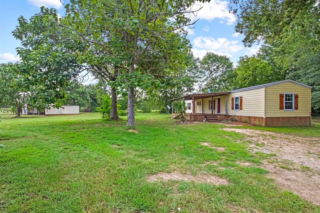 a view of a house with a backyard