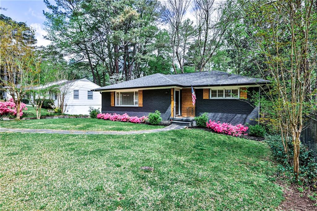 a front view of house with yard and trees