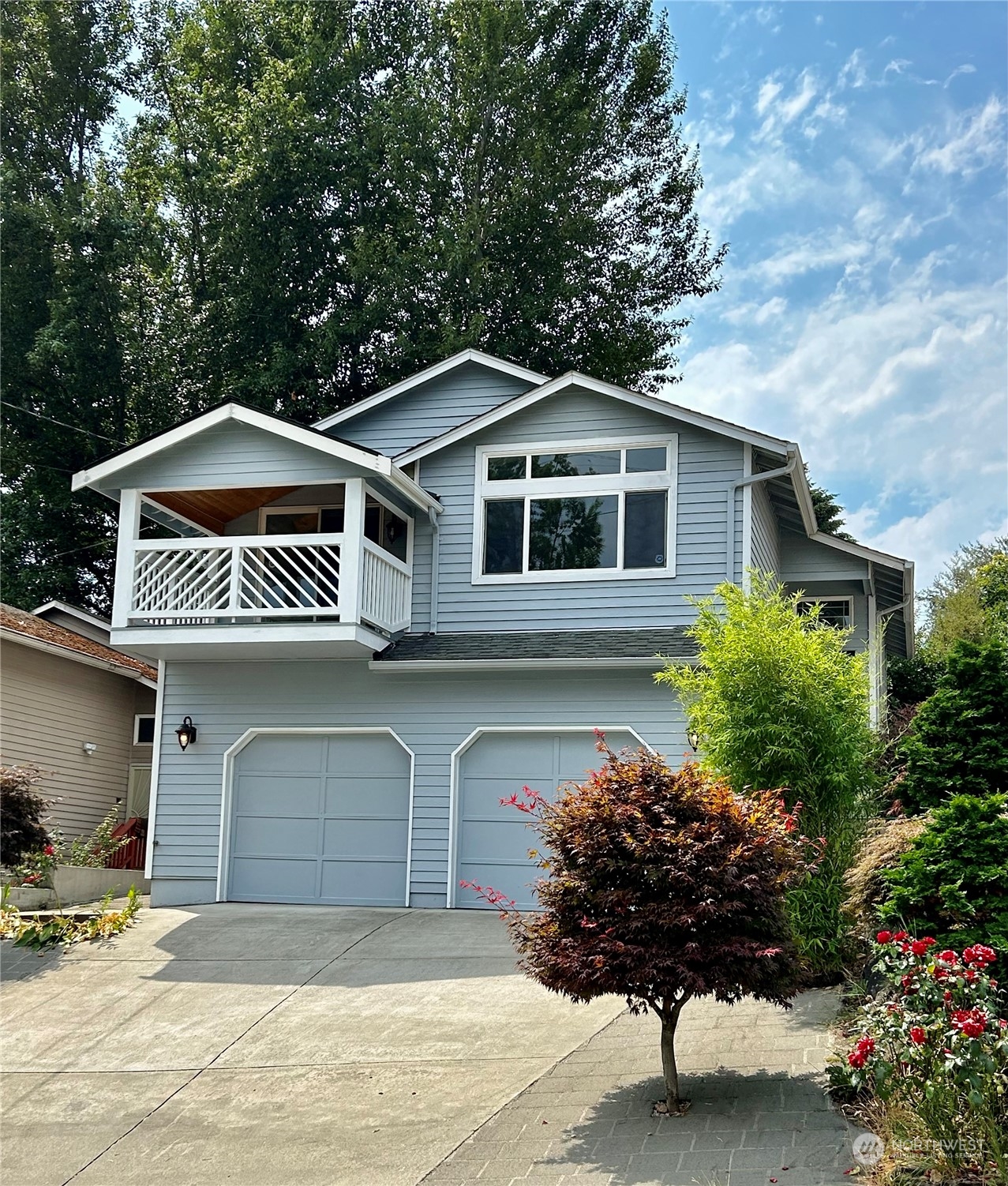 a front view of a house with a garden