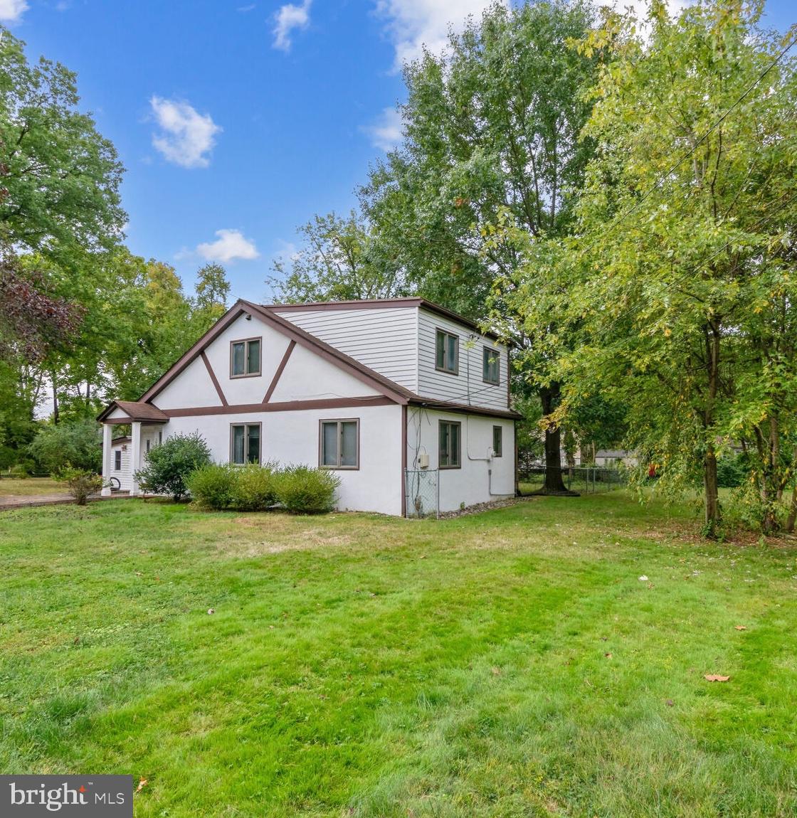 a front view of a house with a yard and trees