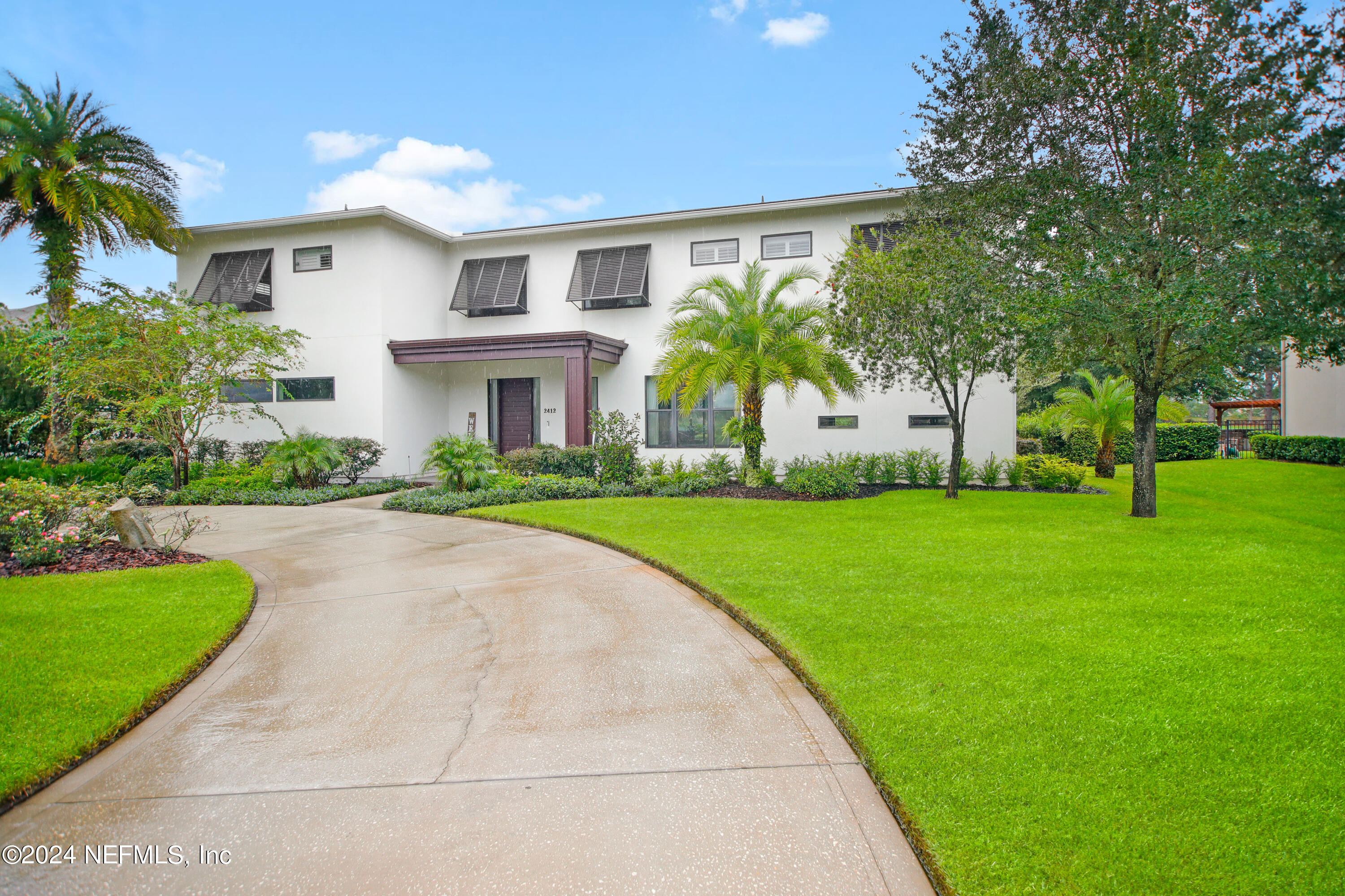 a front view of house with yard and green space