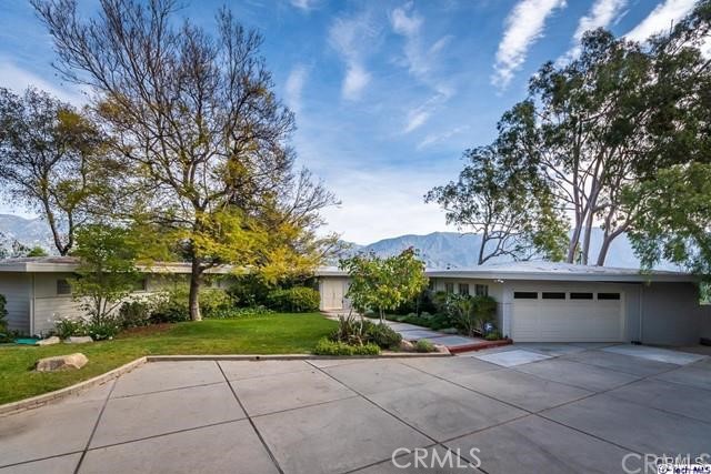 a view of house with yard and entertaining space