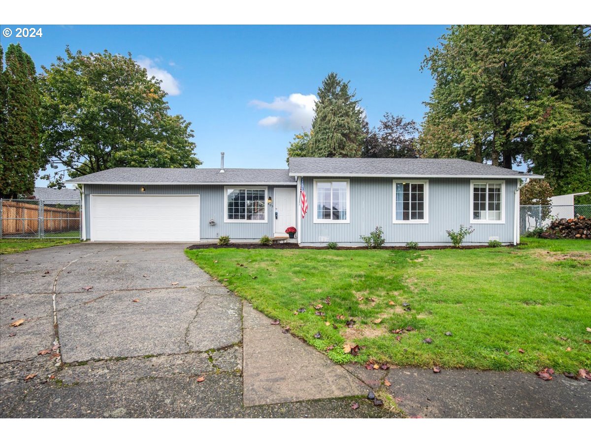 a front view of house with yard and green space