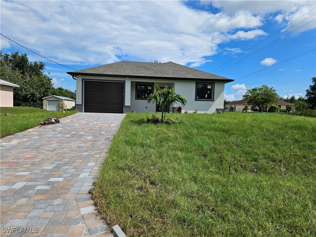 a front view of a house with garden