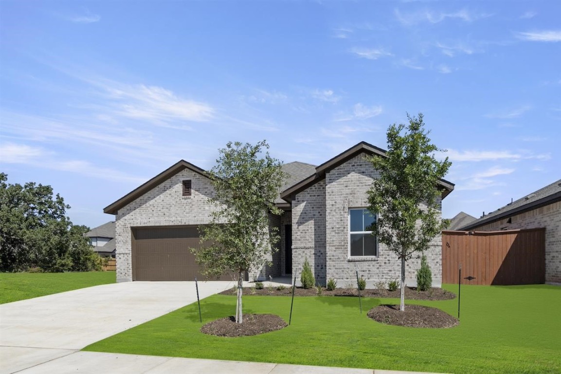 a front view of house with yard and green space